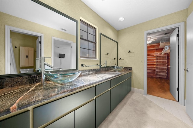 full bathroom with a sink, tile patterned flooring, double vanity, and visible vents