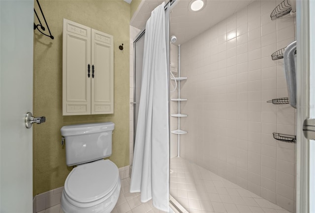 bathroom with toilet, tile patterned flooring, and a stall shower