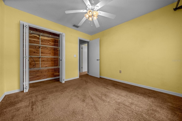 unfurnished bedroom with visible vents, a ceiling fan, carpet, and baseboards