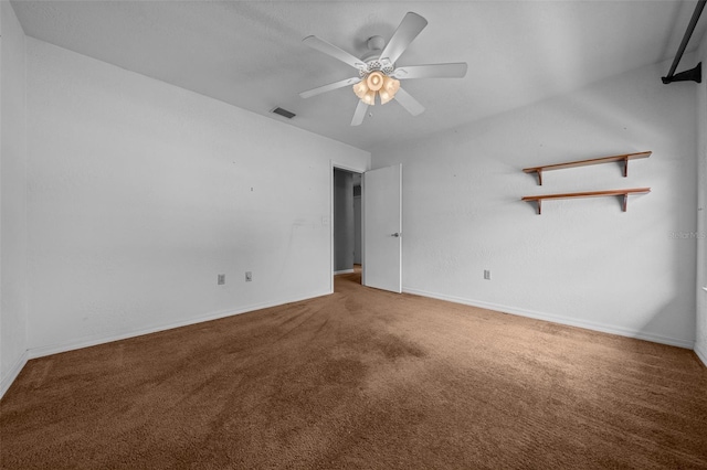 interior space featuring carpet floors, a ceiling fan, baseboards, and visible vents