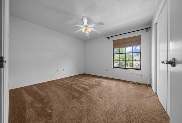 empty room featuring carpet flooring, ceiling fan, and baseboards