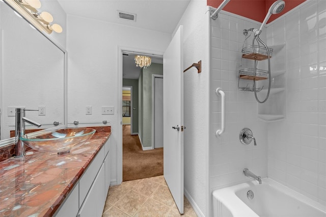 bathroom featuring shower / washtub combination, vanity, tile patterned floors, and visible vents