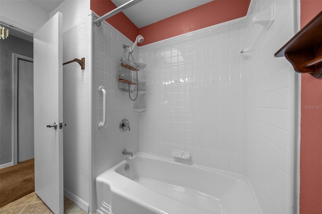 full bathroom featuring a textured wall and shower / bathing tub combination
