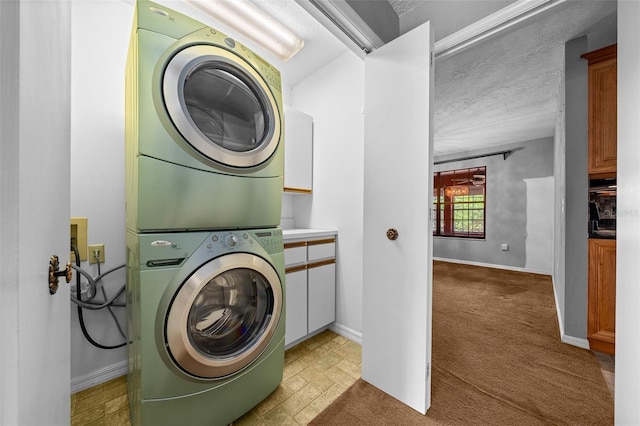 laundry room with laundry area, baseboards, stacked washer / dryer, and light carpet