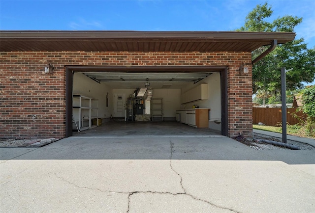 garage with fence and driveway