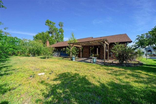 back of house with a patio area, a yard, and a pergola