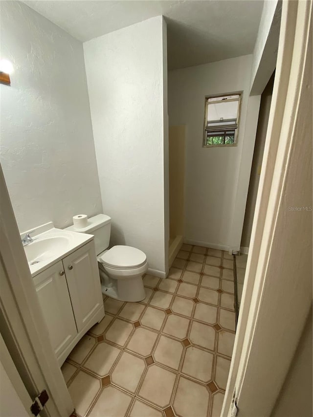 3900 NW 21st Ter, Gainesville, FL 32605 - bathroom with tile patterned floors, toilet, and vanity