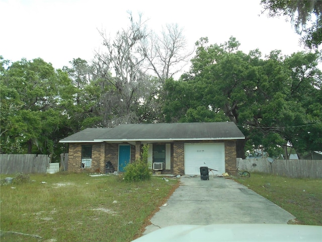ranch-style house with driveway, a front yard, brick siding, fence, and an attached garage