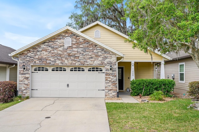 1488 NW 120th Way, Gainesville, FL 32606 - craftsman house featuring concrete driveway, a front yard, an attached garage, and stone siding