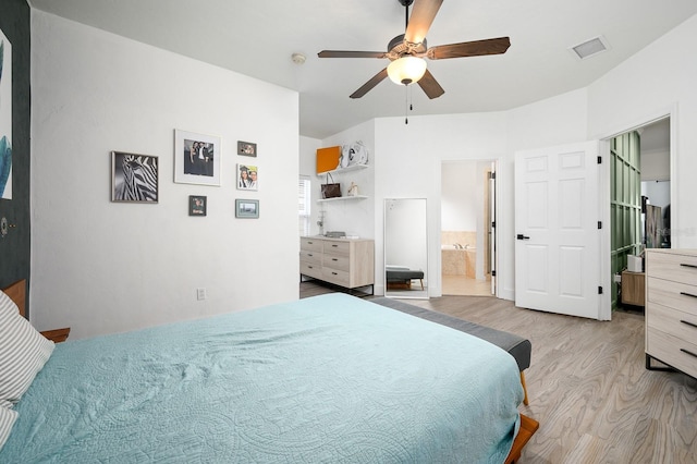 1488 NW 120th Way, Gainesville, FL 32606 - bedroom featuring ceiling fan, connected bathroom, wood finished floors, and visible vents