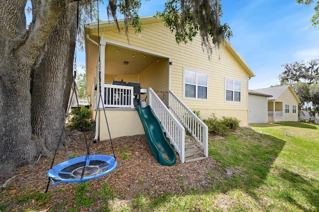 1488 NW 120th Way, Gainesville, FL 32606 - back of house featuring a lawn and stairs