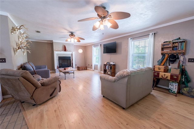 5876 SW 52nd Ter, Lake Butler, FL 32054 - living room with visible vents, light wood-style flooring, crown molding, and ceiling fan