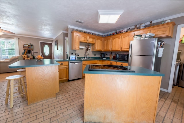 5876 SW 52nd Ter, Lake Butler, FL 32054 - kitchen featuring separate washer and dryer, a kitchen island, black appliances, and brick floor