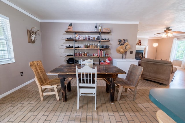 5876 SW 52nd Ter, Lake Butler, FL 32054 - dining room featuring crown molding, a ceiling fan, brick floor, and a warm lit fireplace