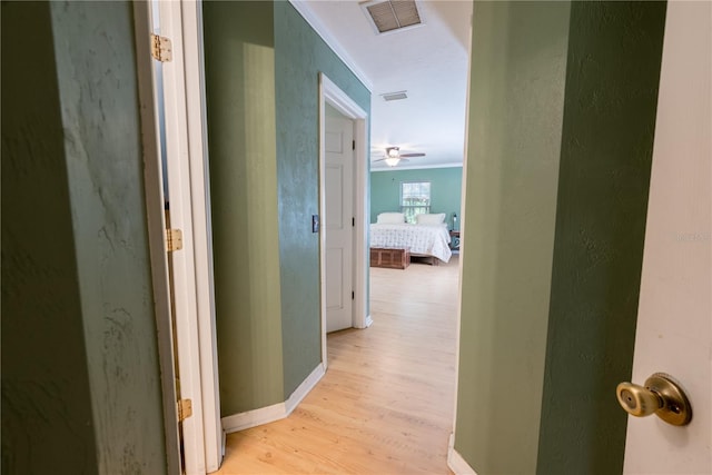 5876 SW 52nd Ter, Lake Butler, FL 32054 - hallway featuring crown molding, baseboards, visible vents, and light wood-style floors