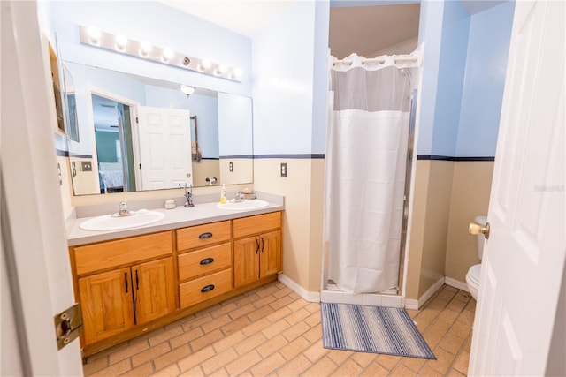 5876 SW 52nd Ter, Lake Butler, FL 32054 - ensuite bathroom with double vanity, a sink, a stall shower, and toilet