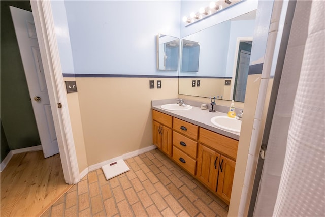 5876 SW 52nd Ter, Lake Butler, FL 32054 - bathroom featuring a sink, baseboards, brick floor, and double vanity
