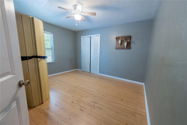 5876 SW 52nd Ter, Lake Butler, FL 32054 - unfurnished bedroom featuring light wood-type flooring, baseboards, ceiling fan, and a closet
