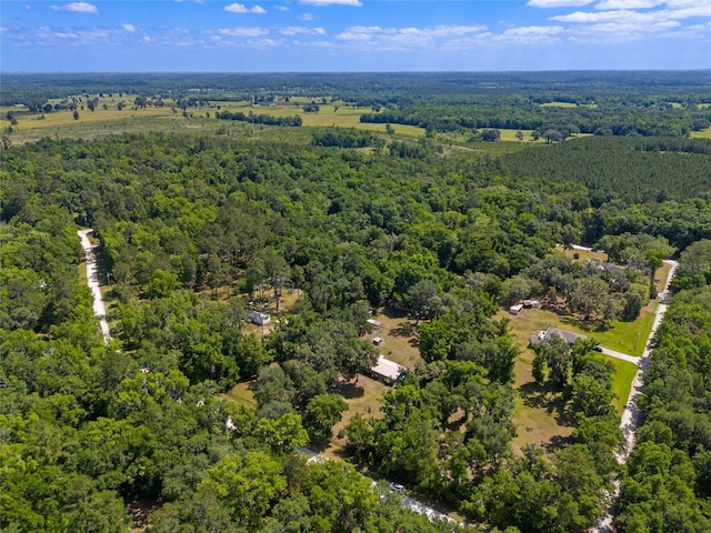 birds eye view of property featuring a wooded view