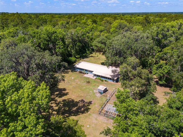 birds eye view of property featuring a view of trees
