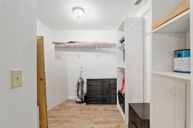 walk in closet featuring visible vents and light wood finished floors