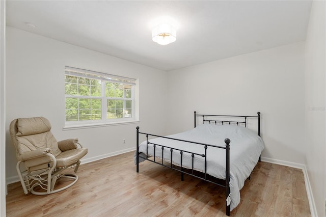 bedroom featuring baseboards and light wood-type flooring