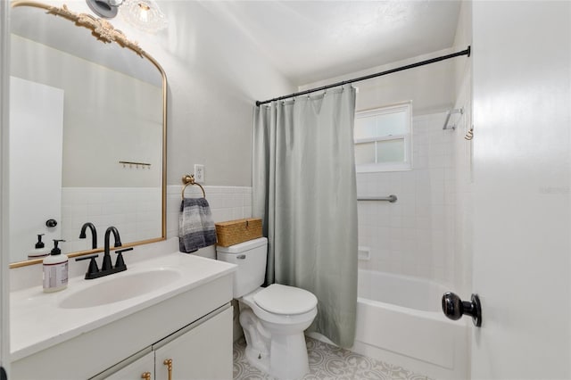 bathroom with vanity, toilet, tile walls, and shower / bath combo with shower curtain