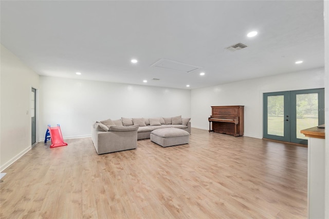 living room featuring french doors, visible vents, light wood-type flooring, baseboards, and recessed lighting