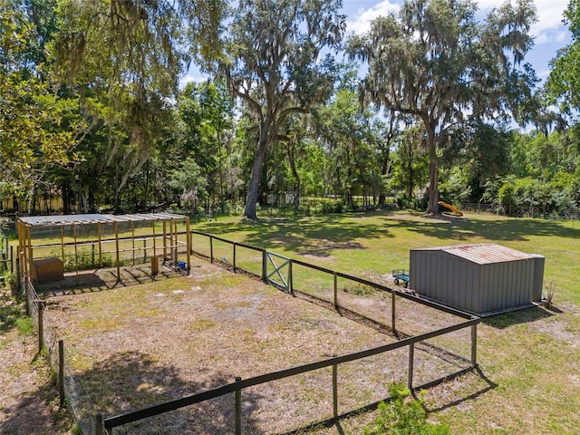 view of yard featuring fence and an outdoor structure