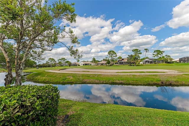 view of community with a residential view, a water view, and a yard