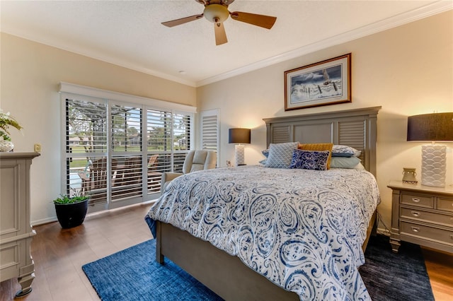 bedroom featuring ceiling fan, ornamental molding, and wood finished floors