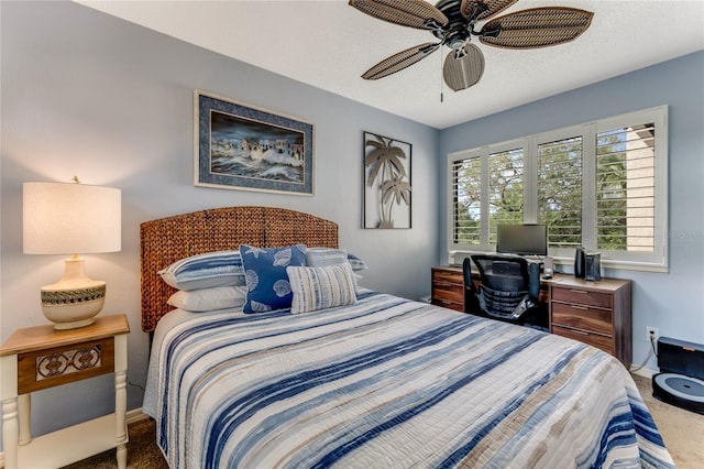 carpeted bedroom with baseboards, a ceiling fan, and a textured ceiling