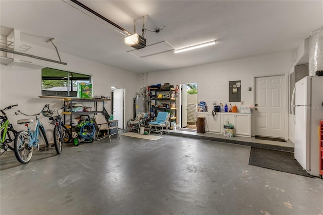 garage featuring freestanding refrigerator, a garage door opener, and electric panel
