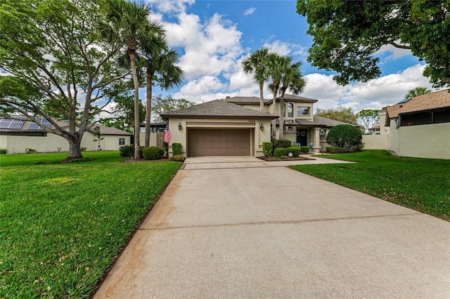 prairie-style home featuring an attached garage, a front lawn, stucco siding, and concrete driveway