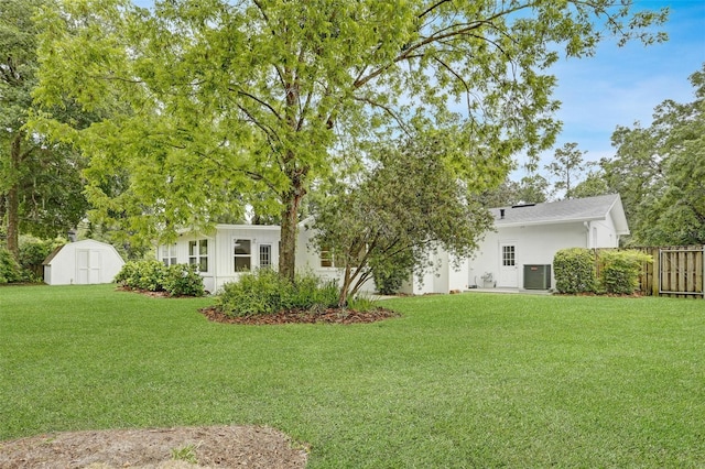 4624 NW 16th Pl, Gainesville, FL 32605 - view of yard with fence, a storage unit, an outdoor structure, and cooling unit
