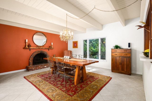 dining room with a brick fireplace, a chandelier, baseboards, light tile patterned floors, and beamed ceiling