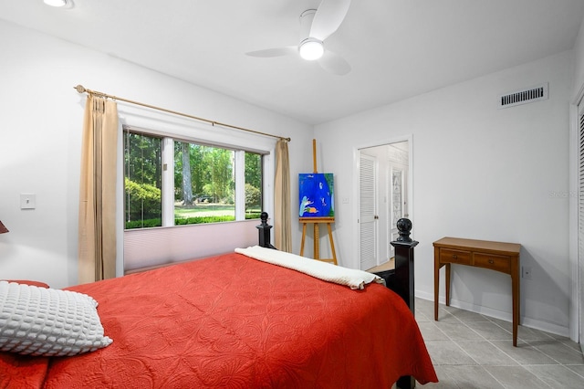 bedroom featuring visible vents, baseboards, ceiling fan, and tile patterned flooring