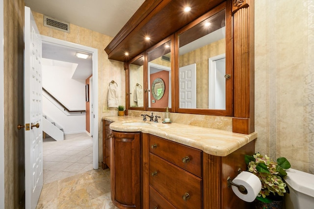 bathroom with vanity, baseboards, tile patterned floors, and visible vents