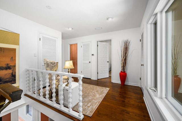 interior space featuring baseboards and wood finished floors