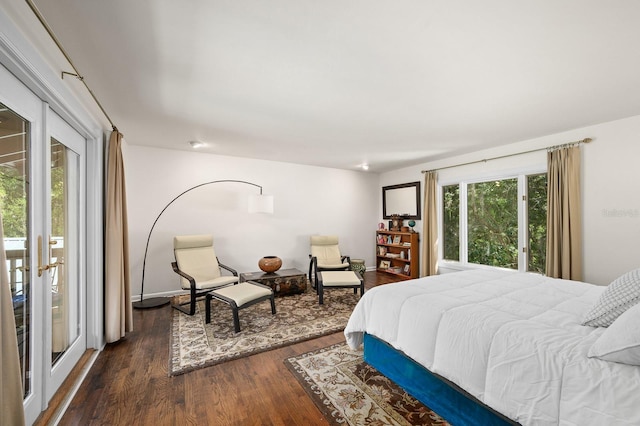 bedroom with access to outside and dark wood-style floors