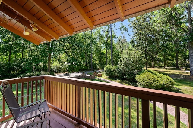 wooden deck with a lawn
