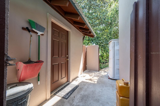 doorway to property featuring stucco siding