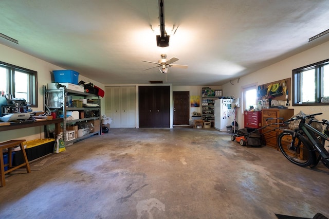 garage featuring a garage door opener and a ceiling fan