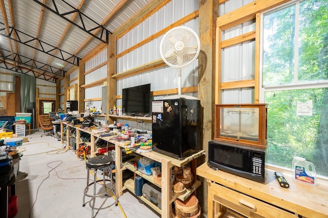 interior space featuring a workshop area and metal wall