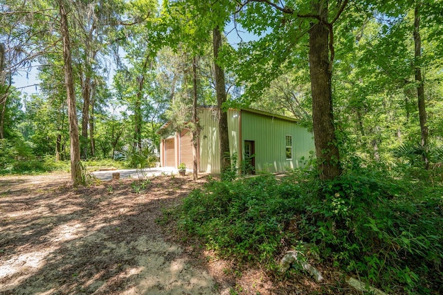 view of yard with a garage and driveway