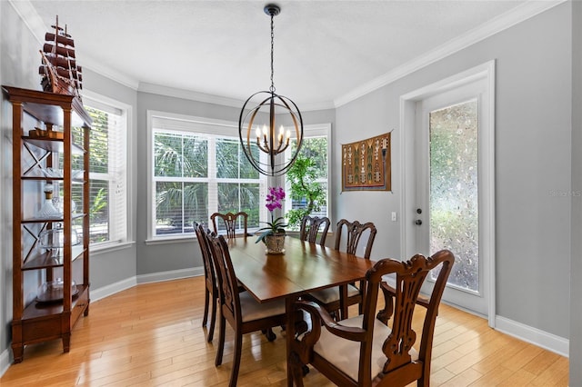 4073 SW 21st Ter, Gainesville, FL 32608 - dining area featuring baseboards, an inviting chandelier, a healthy amount of sunlight, and light wood-style floors