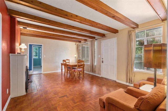 interior space featuring baseboards and beamed ceiling
