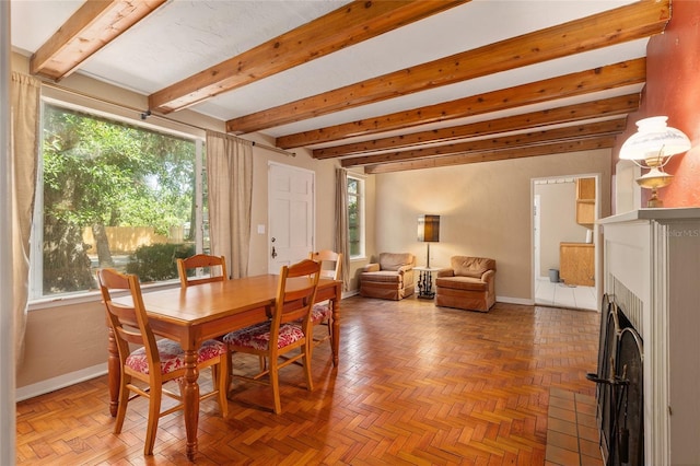 dining room featuring baseboards, a fireplace with flush hearth, and beam ceiling