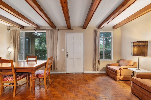 interior space featuring baseboards and beam ceiling