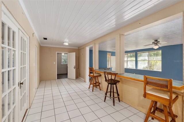 kitchen featuring a ceiling fan, french doors, and light tile patterned floors